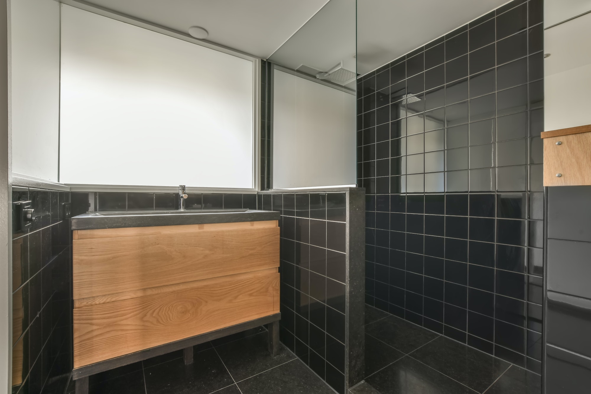 Bathroom interior with black tiles
